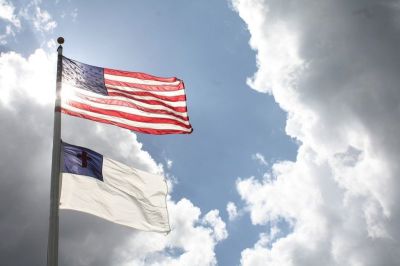 A Christian flag flies below the flag of the United States.