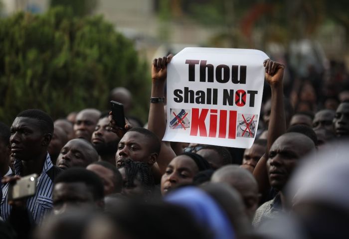 Christians hold signs as they march on the streets of Abuja during a prayer and penance for peace and security in Nigeria in Abuja on March 1, 2020. The Catholic Bishops of Nigeria gathered faithfuls as well as other Christians and other people to pray for security and to denounce the barbaric killings of Christians by the Boko Haram insurgents and the incessant cases of kidnapping for ransom in Nigeria.