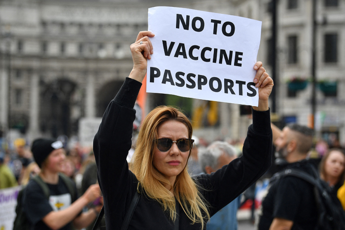 A protestor displays an anti-vax placard during a 'Unite For Freedom' march against COVID-19 vaccinations and government lockdown restrictions, in Trafalgar Square, central London, England, on May 29, 2021.