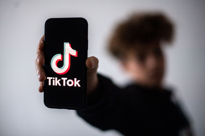 A teenager presents a smartphone with the logo of Chinese social network Tik Tok, on January 21, 2021, in Nantes, western France.