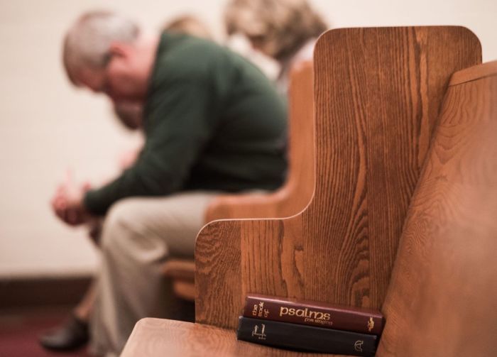 People bow their heads in prayer during a Sunday evening service at Grace Orthodox Presbyterian Church in Lynchburg, Virginia, on January 17, 2016.
