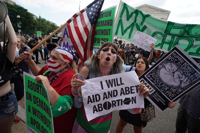 Pro-choice and anti-abortion demonstrators gather outside the U.S. Supreme Court in Washington, D.C., on June 24, 2022.