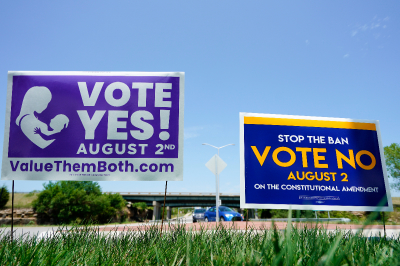 Signs in favor and against the Kansas constitutional amendment on abortion are displayed outside Kansas 10 highway on Aug. 1, 2022 in Lenexa, Kansas.