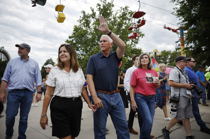 Former U.S. Vice President and current presidential candidate Mike Pence (C) and his wife Karen Pence (L) and Sen. Joni Ernst, R-Iowa, tour the Iowa State Fair on August 11, 2023, in Des Moines, Iowa.