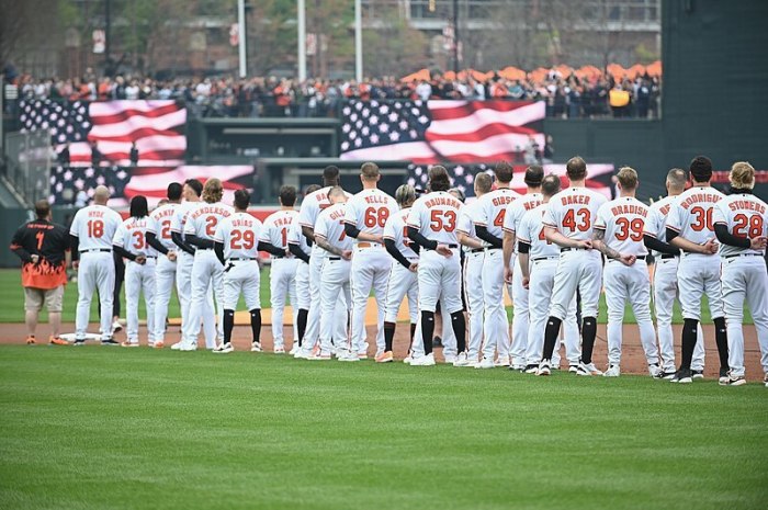 The Baltimore Orioles stand for the singing of the national anthem before their Opening Day game in Baltimore, Maryland, on April 7, 2023.