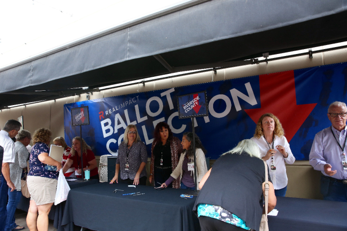 Churchgoers of Calvary Chapel Chino Hills are directed to drop their ballots off to specific tables based on which of four southern California counties they reside in.