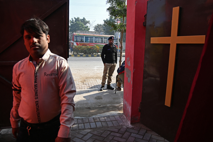 A police officer stands guard outside the rehabilitated Presbyterian Church on Christmas Day in Jaranwala on December 25, 2023. More than 80 Christian homes and 19 churches were vandalized in an hours-long riot in Jaranwala in Punjab province on August 16, 2023, after allegations that a Koran had been desecrated spread through the city.