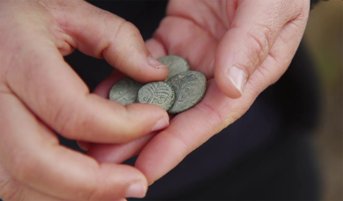 Archeologists find second century coins in the Judean Desert. One coin is engraved with the name “Eleazar the Priest” in ancient Hebrew script.