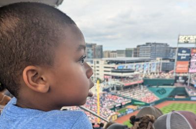 Kristian Alston enjoying his first baseball game during a McLean Faith Family Day.
