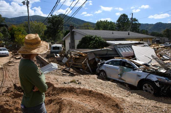 Emily Ogburn looks at her partner's home after it was destroyed by flooding on Oct. 2, 2024, in Swannanoa, North Carolina. According to reports, at least 160 people have been killed across the southeastern U.S., and more than a million are still without power due to the storm. The White House has approved disaster declarations in multiple southern states, freeing up federal emergency management money and resources.