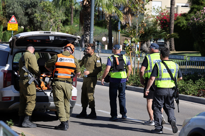 Members of the Israeli security forces walk along a street leading to Prime Minister Benjamin Netanyahu's residence in Caesarea on Oct. 19, 2024. Netanyahu's office said a drone was launched toward his residence on Oct. 19, after the military reported a drone from Lebanon had 'hit a structure' in the central Israeli town.