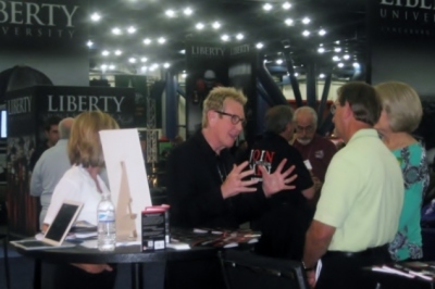 Pastor Jay Dennis of First Baptist Church at the Mall in Lakeland, Fla., shares the 'Join 1 Million Men' project in the exhibit hall at the Southern Baptist Convention in Houston, Texas, on June 11, 2013.